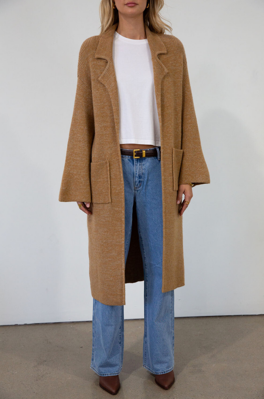 Fuzzy heather knit longline cardigan. Collar neckline. Long sleeves. Front pockets. Open front. Unlined. fall cardigan. tan long cardigan