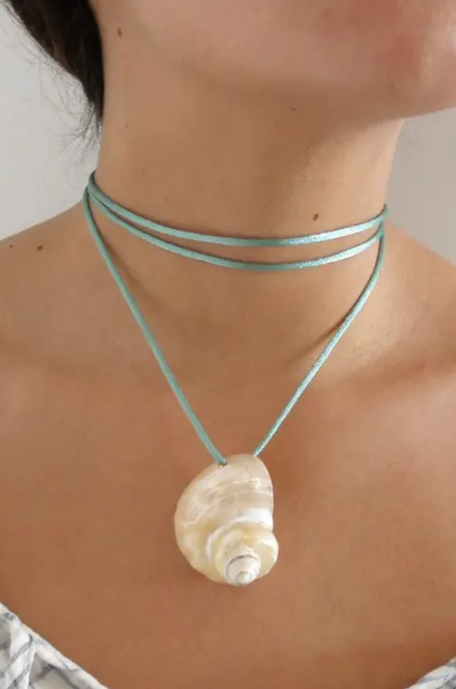 Turbo shell silk cord necklace
Polished and hand-drilled
Silk cord with gold plated beads
Can be worn multiple ways
Length: 26"
Turbo shell approx. 1.5"
Size color and shape of shell may vary slightly