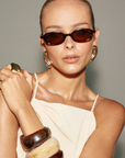 Square sunglasses
Featuring a sharp acetate frame with clean lines and a tortoise frame
Caramel tort – chocolate gradient lenses
Scratch-resistant Category 3 lenses
100% UV protection
Subtle branded detail on inner arms\
Width: 13.8m / Lens Heigh: 3.34cm / Arm Length: 14.2cm / Nose Bridge: 2.2cm
brown tort sunglasses