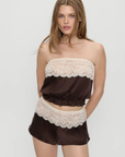 Strapless silk blouse
Gentle elastic to hold itself in place
Lace detailing
Rosette accent at center front
Silk
brown silk tube top