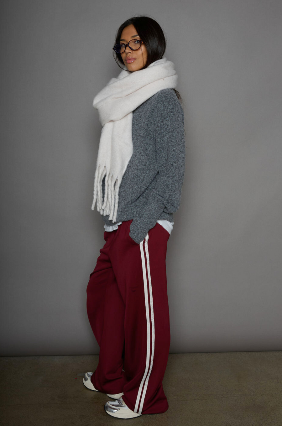 Woven burgundy track pants. Elastic waistband. Side pockets. Side stripes. Unlined. street fashion. trendy track pants