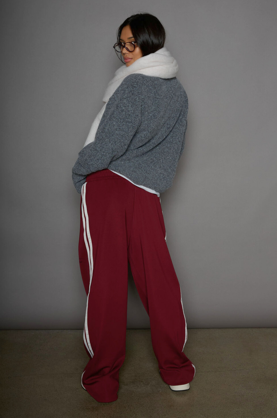Woven burgundy track pants. Elastic waistband. Side pockets. Side stripes. Unlined. street fashion. trendy track pants