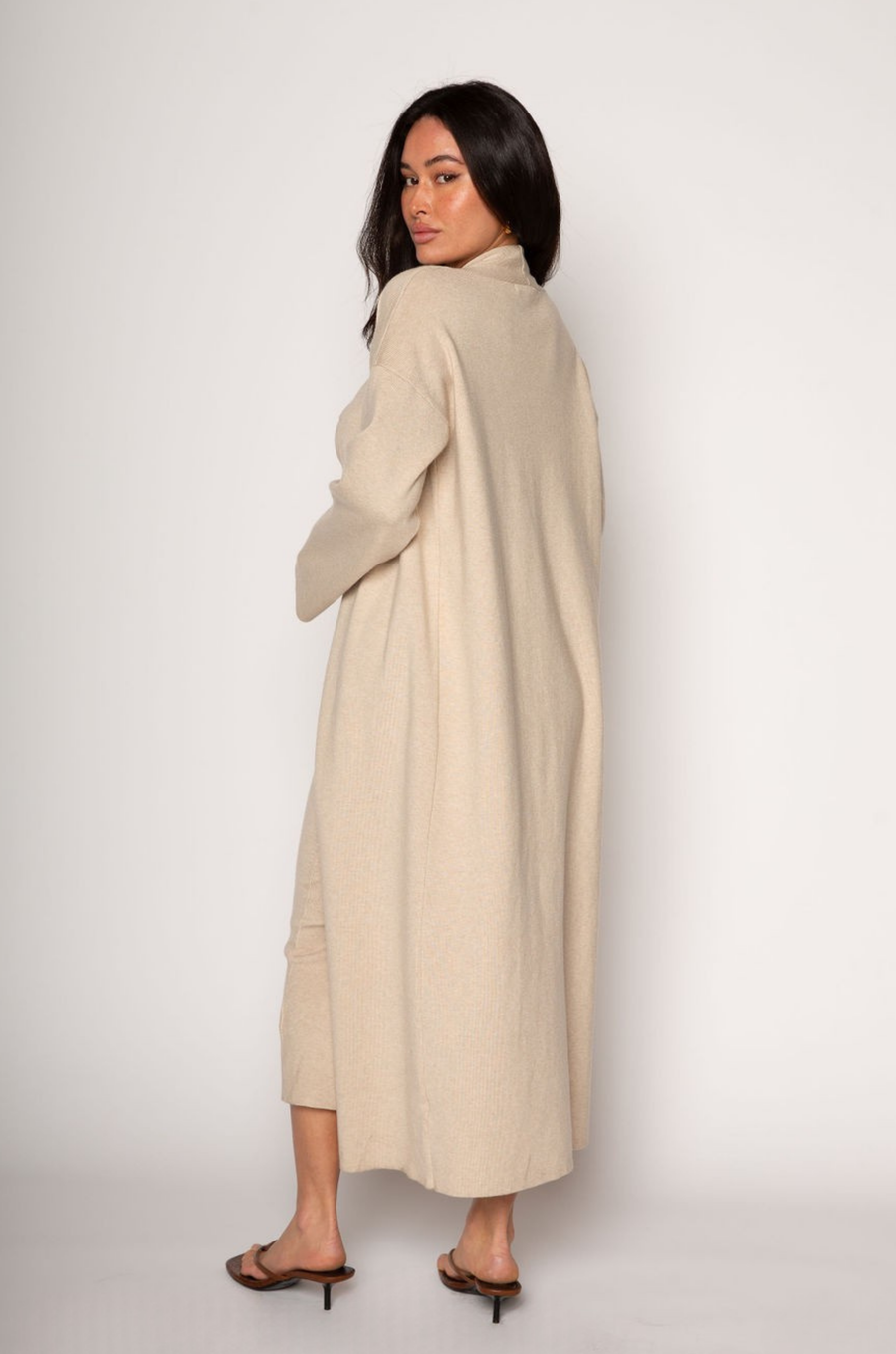 Ribbed knit longline cardigan. Open front. Long sleeves. Unlined. Ribbed knit maxi dress. Strapless elastic folded neckline. Back slit. Unlined. tan dress cardigan set