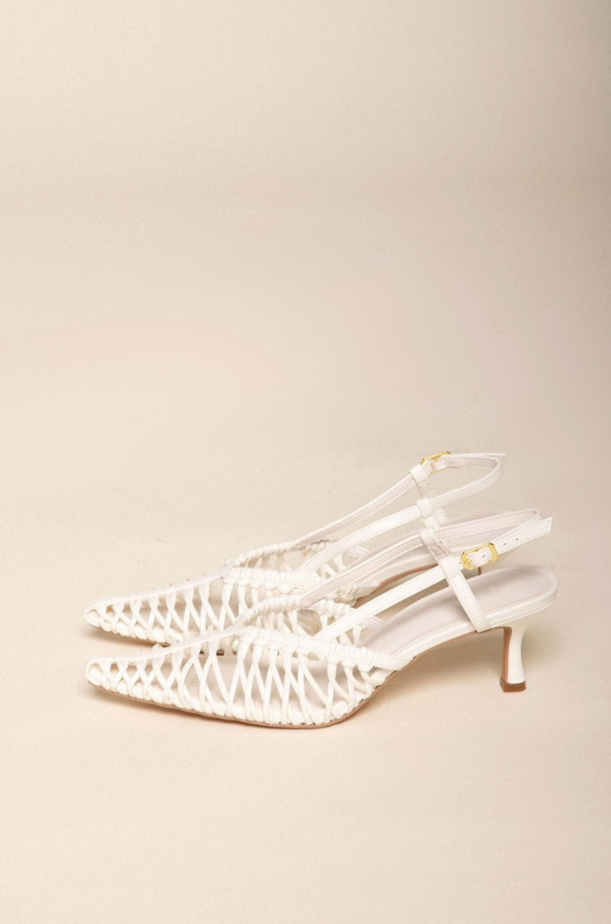 Low kicked-in stiletto heel
Closed pointed toe
Strappy detailing on vamp
Sling back ankle strap with adjustable buckle
Exposed heel counter
Heel height: 6cm
Synthetic upper
white scrappy heel
bridal heels