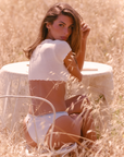 white Knit crop top
Short sleeve
Scalloped trim
Heart detailing
Adjustable front tie