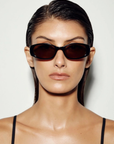 Vintage-inspired sunglasses. Featuring a sleek horizontally elongated oval shape with softly rounded lenses, this statement silhouette is set within a thick dark frame that slightly widens at the outer edges for a modern sporty finish.

Featuring:

elongated oval frame silhouette
acetate frame
softly rounded lens shape
thick dark frame design with widened outer edges
retro-inspired sporty aesthetic
smooth curved detailing
polarisation degree | A degree
UV protection | Cat 3