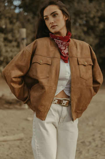 Tan brown faux suede jacket. Front zipper closure. Front and side pockets. Long sleeves with button closures. Fully lined. suede bomber jacket