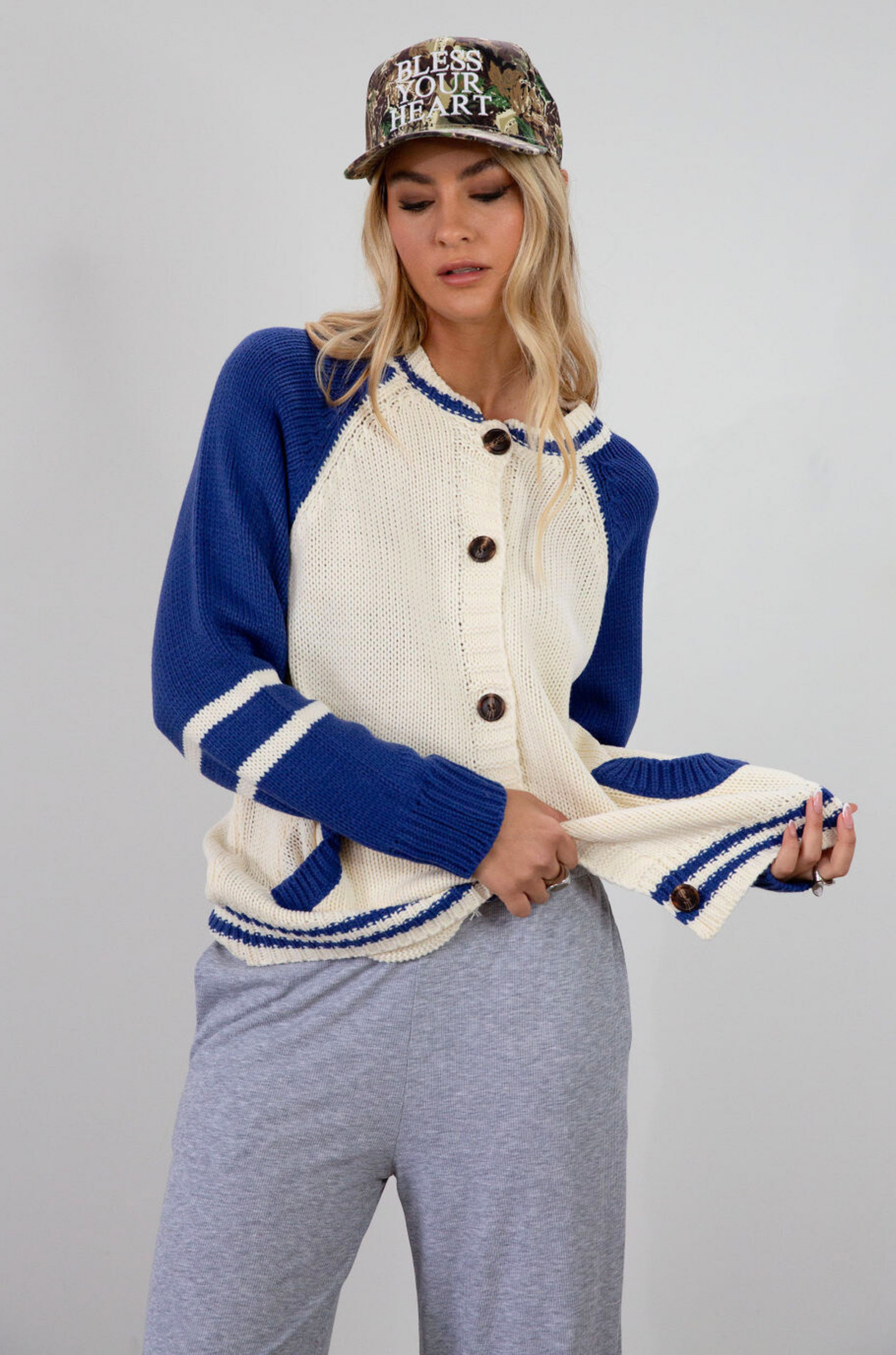 Colorblocked crochet knit cardigan. Crewneck. Long sleeves. Front button down closures. Front pockets. Unlined. ivory and blue sweater cardigan. fall top. fall sweater. oversized sweater