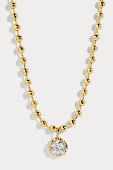Delicate ball chain necklace anchored with a luminous CZ pendant
14kt gold plated brass&nbsp;or Rhodium plated brass
Stone is a white cz and measures 8.0mmNecklace measures 16" with a 3" extender
Lobster Clasp Closure
Gold chain necklace