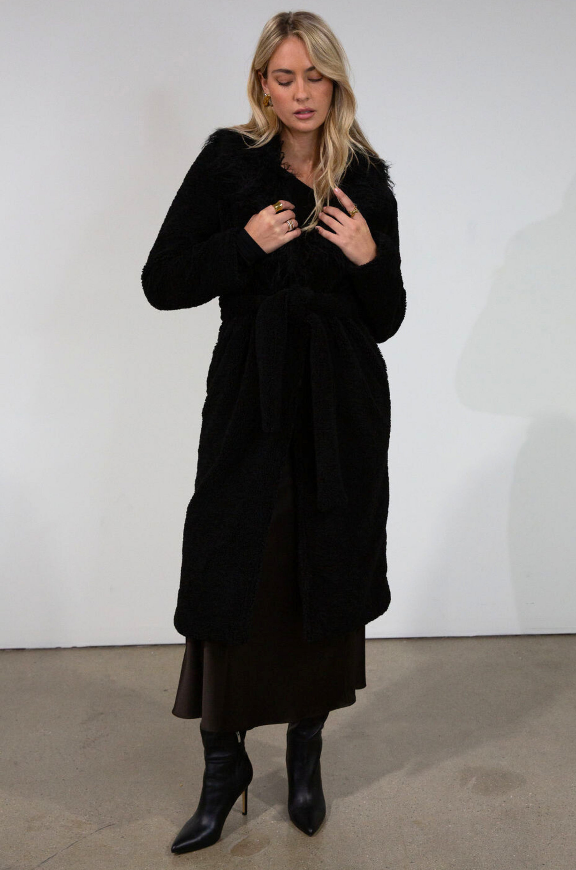 Black Faux sherpa longline coat. Faux fur collar neckline. Front snap button closure. Tie waist. Side pockets. Back slit. Fully lined. long coat. coat for new york. fall coat. fall outfit