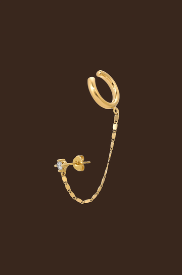 Designed in 14K gold plating, this design features an ear cuff enhanced by a delicate chain that attaches to a glistening cubic zirconia crystal stud, giving you a vibrant sparkle.&nbsp;
