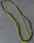 Two separate elastic multicolor beaded belly chains. yellow and black belly chain