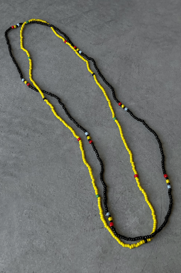 Two separate elastic multicolor beaded belly chains. yellow and black belly chain
