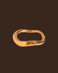 Gold waved ring on a dark brown background