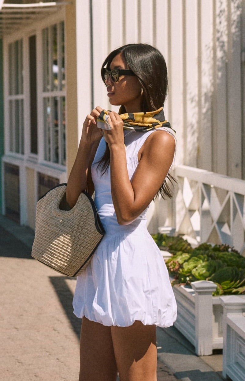Woven sleeveless dress. Drop waist. Bubble skirt. Side hook and eye and zipper closures. Adjustable lace up back closure. Fully lined. white mini bubble skirt. summer dress. vacation dress. vacation outfit. nice dress. european summer dress. european summer outfit. european summer vacation