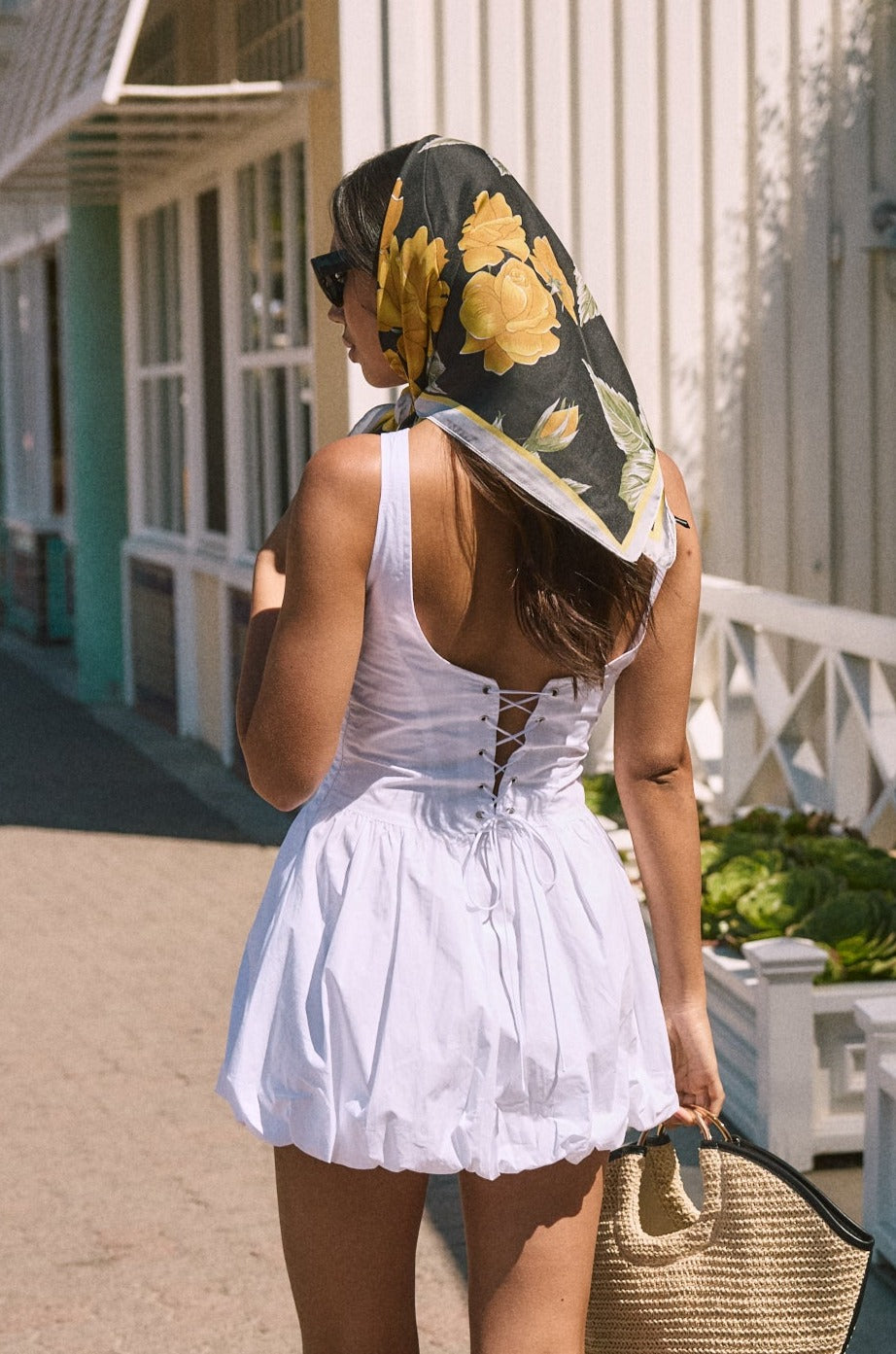 Woven sleeveless dress. Drop waist. Bubble skirt. Side hook and eye and zipper closures. Adjustable lace up back closure. Fully lined. white mini bubble skirt. summer dress. vacation dress. vacation outfit. nice dress. european summer dress. european summer outfit. european summer vacation