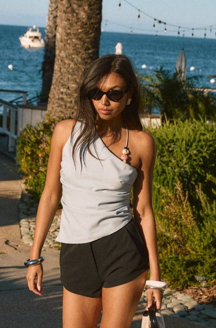 Woven top. Asymmetric neckline. Elastic steps. Beaded details. Ruched side. Side zipper closure. Fully lined. blue tank top. blue asymmetrical tank top. tank top with beads. summer outfit. summer going out top. beach vacation outfit. beach vacation top. fancy dinner top. european summer outfit. european summer top. european summer outfit inspo. vacation outfit