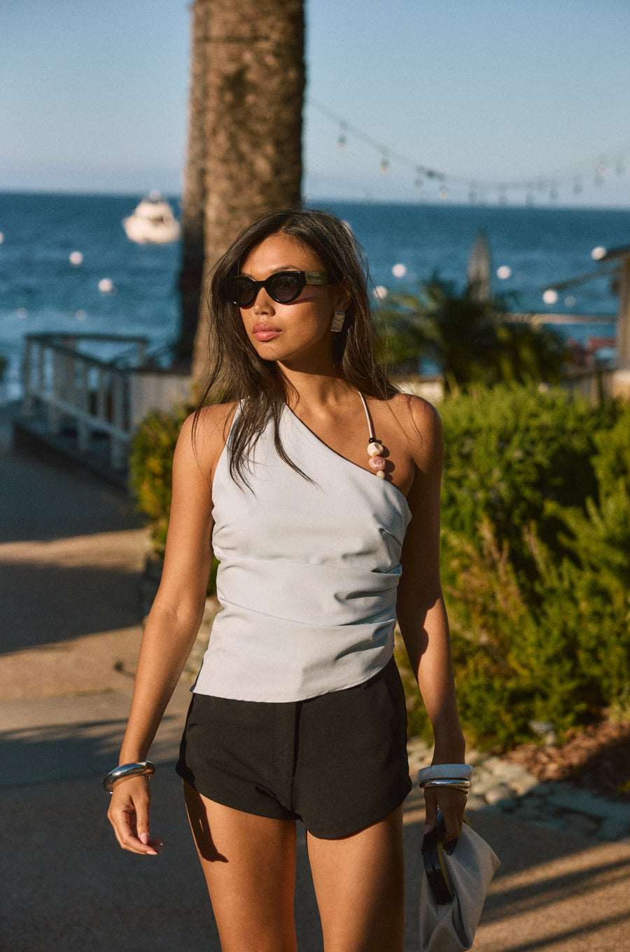 Woven top. Asymmetric neckline. Elastic steps. Beaded details. Ruched side. Side zipper closure. Fully lined. blue tank top. blue asymmetrical tank top. tank top with beads. summer outfit. summer going out top. beach vacation outfit. beach vacation top. fancy dinner top. european summer outfit. european summer top. european summer outfit inspo. vacation outfit
