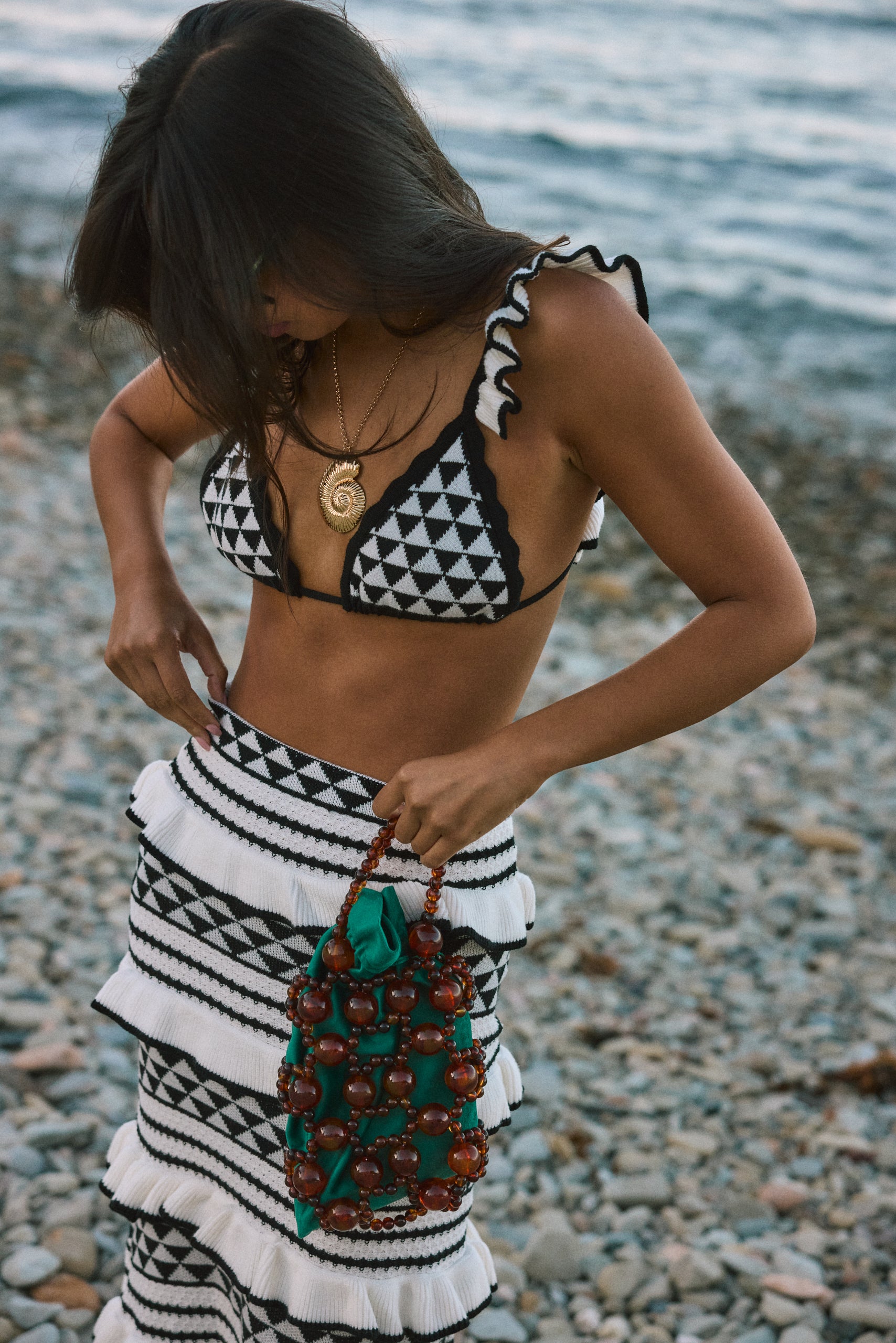 Crochet knit bikini top. Ruffle trim. Adjustable back tie closure. Crochet knit maxi skirt. Elastic waist. Ruffle trim. Unlined. black and white set. black and white skirt set. skirt and crop top set. summer outfit. summer going out set. beach vacation outfit. fancy dinner outfit. european summer outfit. european summer set. european summer outfit inspo. vacation outfit