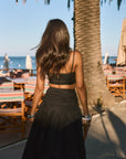 Woven maxi skirt. Ruched details. Side hook and eye and zipper closures. Side pockets. Unlined. summer outfit. summer going out skirt. beach vacation outfit. beach vacation skirt. fancy dinner skirt. european summer outfit. european summer skirt. european summer outfit inspo. vacation outfit. black skirt and cropped tank set