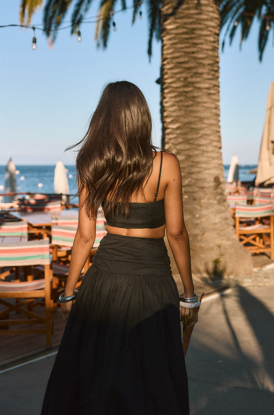 Ruched woven crop top. Adjustable straps. Side zipper closure. Elastic smocked back. Fully lined. black cropped tank top. summer outfit. summer going out top. beach vacation outfit. beach vacation top. fancy dinner top. european summer outfit. european summer top. european summer outfit inspo. vacation outfit. black skirt and cropped tank set