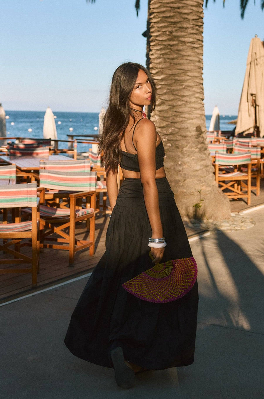Woven maxi skirt. Ruched details. Side hook and eye and zipper closures. Side pockets. Unlined. summer outfit. summer going out skirt. beach vacation outfit. beach vacation skirt. fancy dinner skirt. european summer outfit. european summer skirt. european summer outfit inspo. vacation outfit. black skirt and cropped tank set