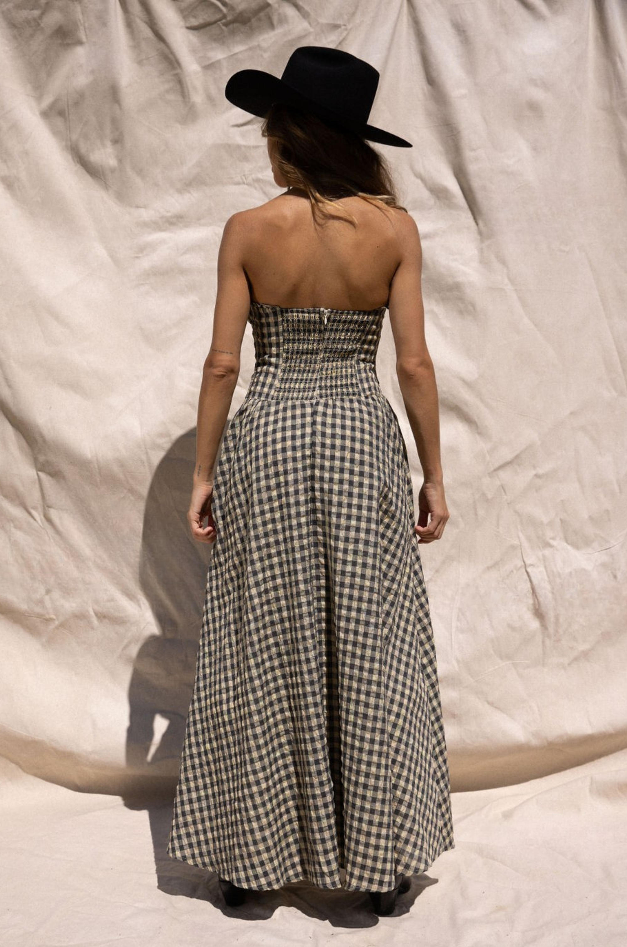Plaid woven maxi dress. Elastic strapless neckline. Inner rubber grip lining. Elastic smocked back panel. Back hook and eye and zipper closures. Fully lined. Paid maxi dress. ranch outfit. western outfit. stagecoach dress. country concert dress. festival outfit