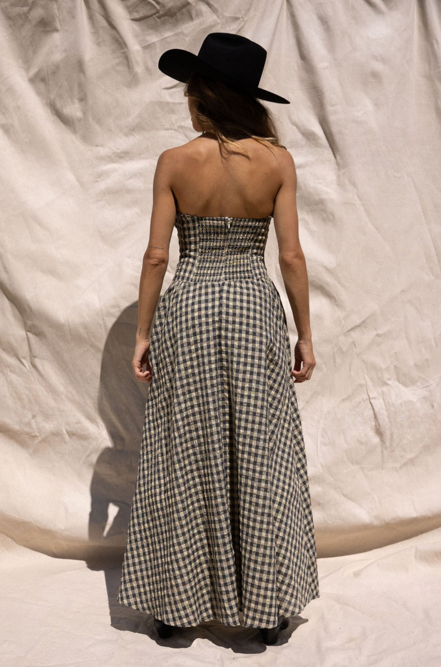Plaid woven maxi dress. Elastic strapless neckline. Inner rubber grip lining. Elastic smocked back panel. Back hook and eye and zipper closures. Fully lined. Paid maxi dress. ranch outfit. western outfit. stagecoach dress. country concert dress. festival outfit