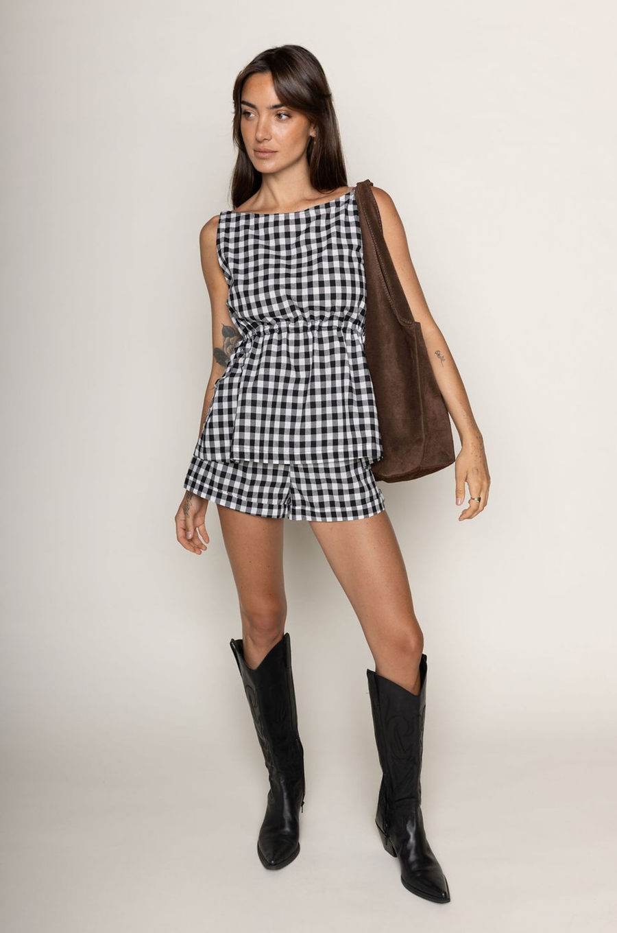 TOP:
Gingham printed flowy tank top
Ruched side ties
Back button closure
Unlined
Length: 21"
Cotton

BOTTOM:
Gingham printed shorts
Elastic waistband
Unlined
Length: 11.5"
Cotton

black and white gingham printed short set
summer set