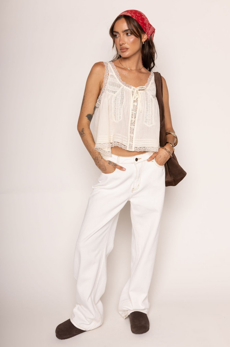 Lace trimmed tank top
Faux front bow tie
Sleeveless
Scoop neckline
Open front with button closure
Unlined
ivory coquette tank top
peasant top
summer flowy tank top