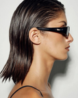 Vintage-inspired sunglasses. Featuring a sleek horizontally elongated oval shape with softly rounded lenses, this statement silhouette is set within a thick dark frame that slightly widens at the outer edges for a modern sporty finish.

Featuring:

elongated oval frame silhouette
acetate frame
softly rounded lens shape
thick dark frame design with widened outer edges
retro-inspired sporty aesthetic
smooth curved detailing
polarisation degree | A degree
UV protection | Cat 3