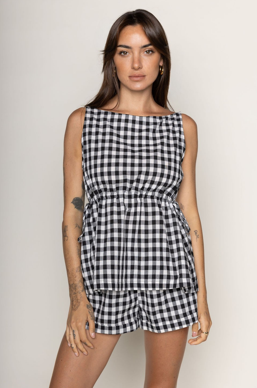 TOP:
Gingham printed flowy tank top
Ruched side ties
Back button closure
Unlined
Length: 21"
Cotton

BOTTOM:
Gingham printed shorts
Elastic waistband
Unlined
Length: 11.5"
Cotton

black and white gingham printed short set
summer set
