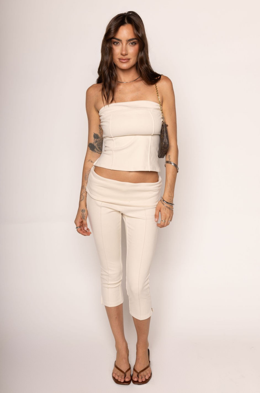 TOP

Tube top
Sweater material
Unlined
Length: 14"
Polyester/Spandex

BOTTOM

Capri pant
Sweater material
Fold over
Length: 28.5"
Polyester/Spandex

cream tube top and capri pant set