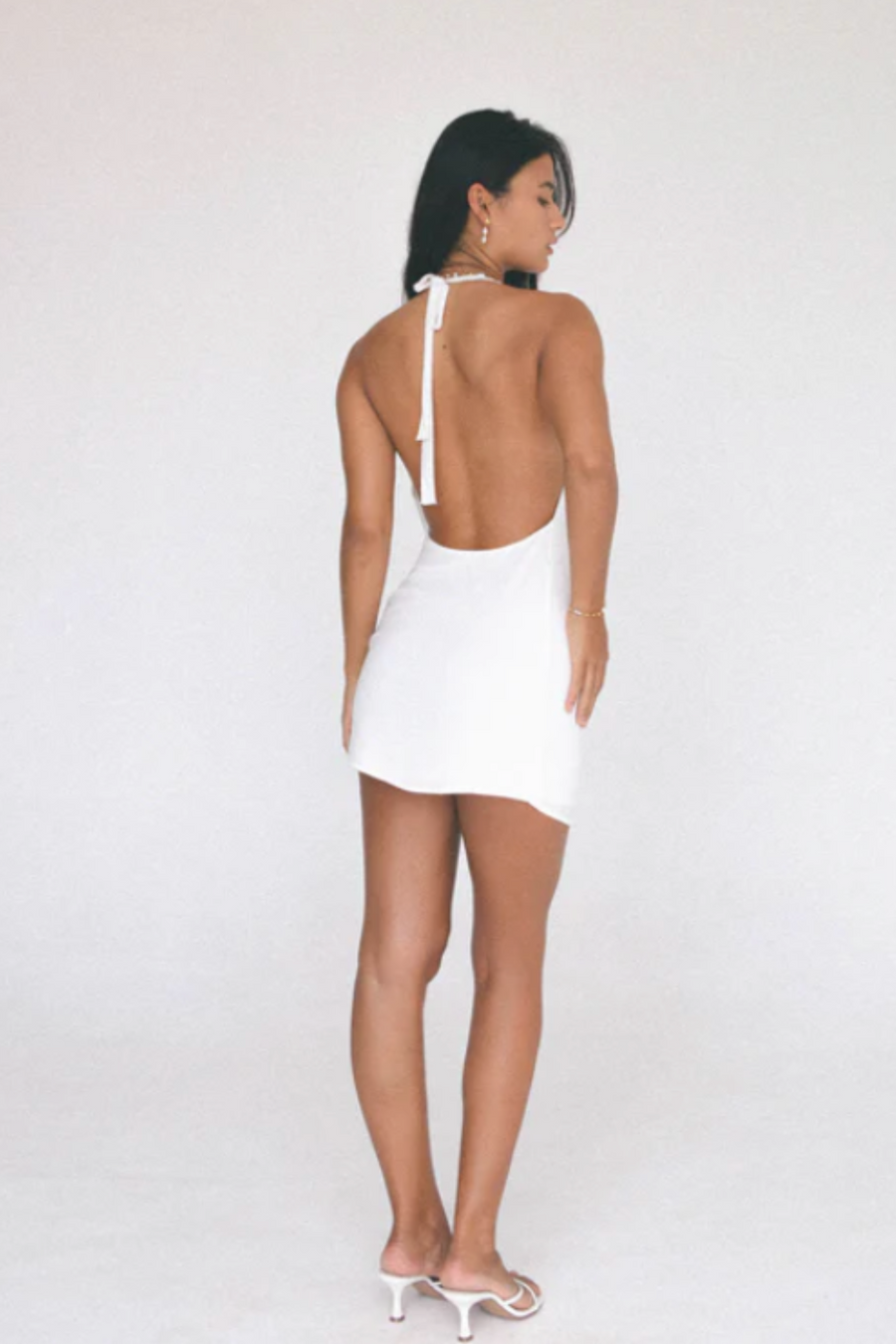 Woven dress. Adjustable halter tie neckline. Low scoop neckline. Fully lined. white mini dress. Deep v dress. low neck line dress. open back dress. open back mini dress