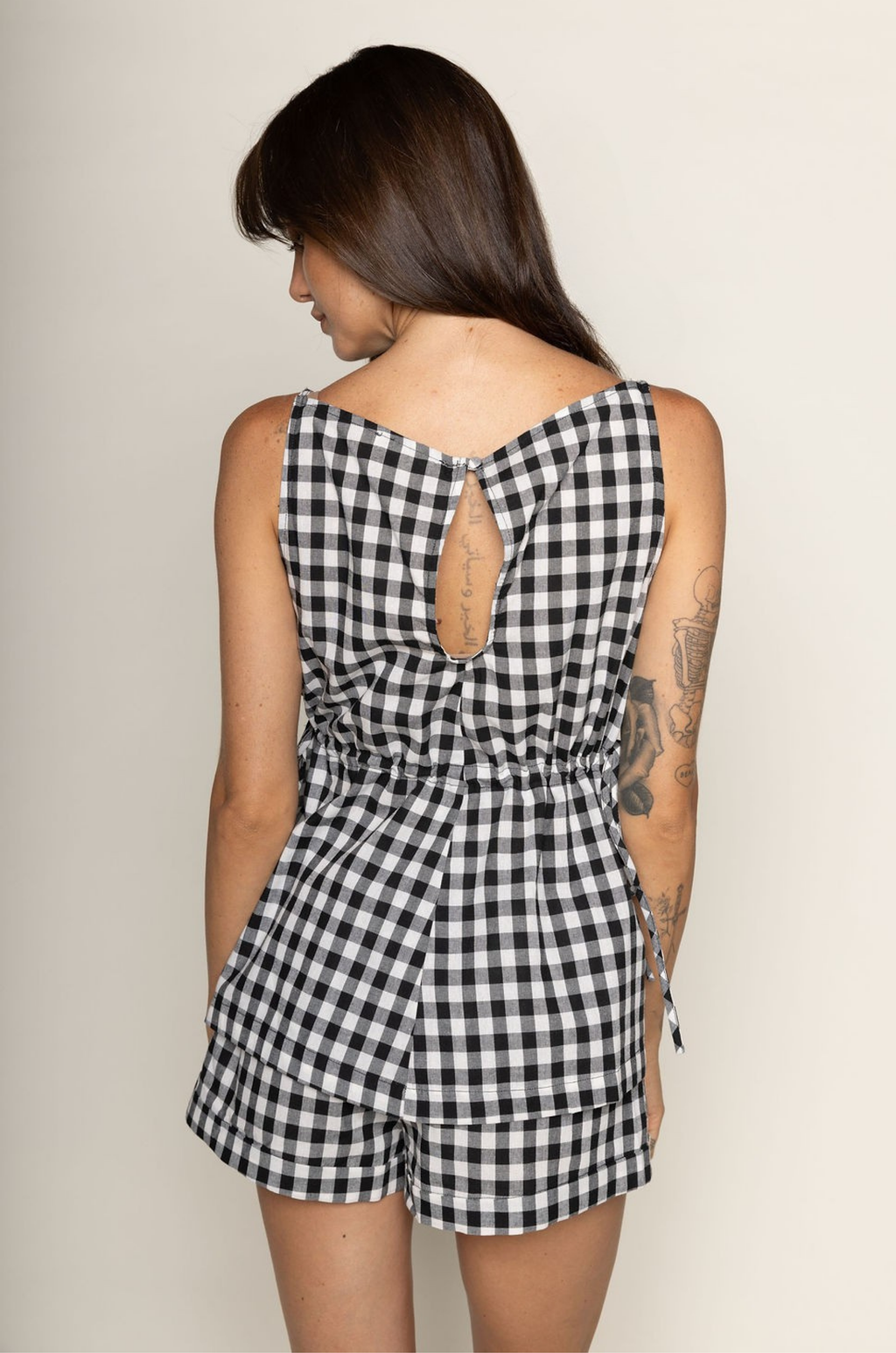 TOP:
Gingham printed flowy tank top
Ruched side ties
Back button closure
Unlined
Length: 21"
Cotton

BOTTOM:
Gingham printed shorts
Elastic waistband
Unlined
Length: 11.5"
Cotton

black and white gingham printed short set
summer set