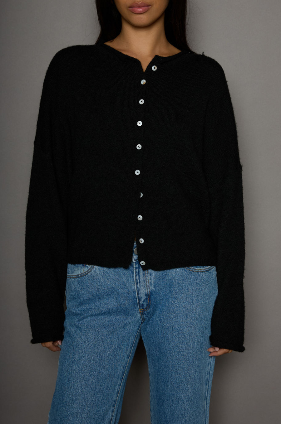 Fuzzy knit cardigan. Crewneck. Front button down closures. Long sleeves. Unlined. black cardigan. fall outfit. fall cardigan. layering piece. layering cardigan