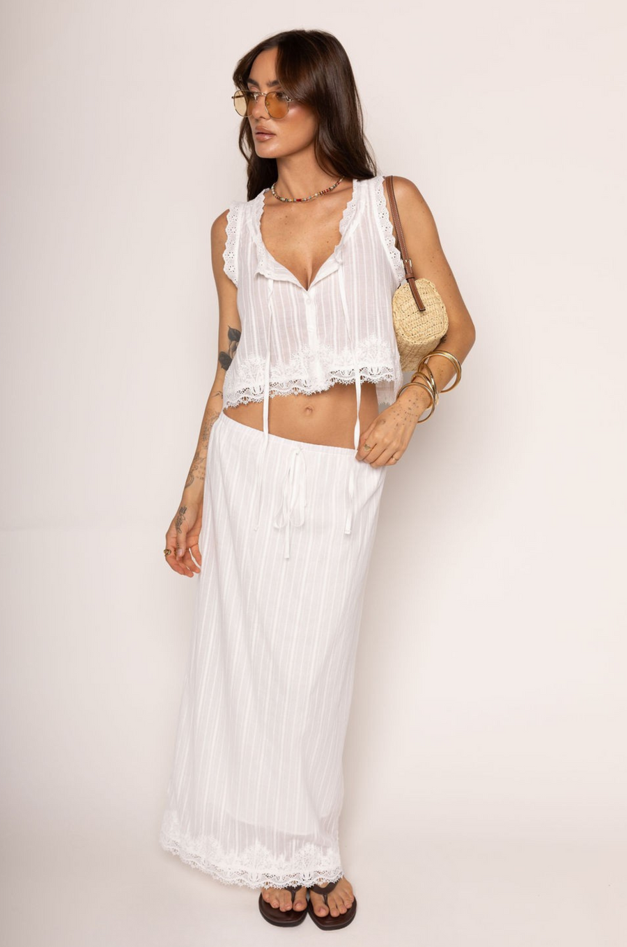Woven linen tank top vest
Eyelet and lace trim
Button down closure
Tie front
Unlined

Woven linen maxi skirt
Lace hem trim
Faux waist tie
Elastic waistband
Back slit
Lined
Length: 35"
Cotton
Summer linen skirt set
east coast outfit inspo