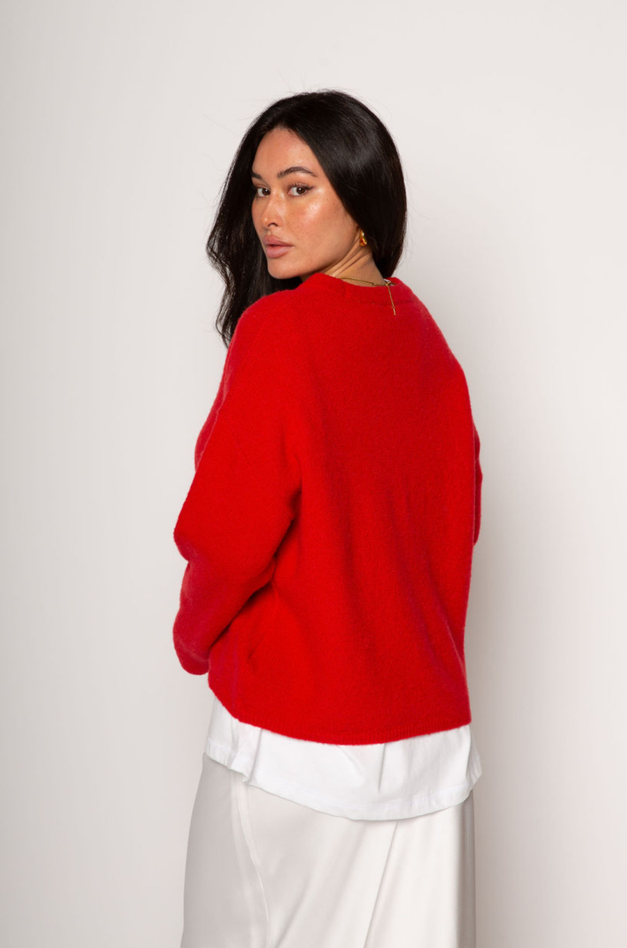 Medium weight knit sweater. Crewneck. Long sleeves. Thin ribbed trim detail at collar, sleeve cuffs, and hemline. Unlined. Pullover style. red pullover sweater. valentines day outfit