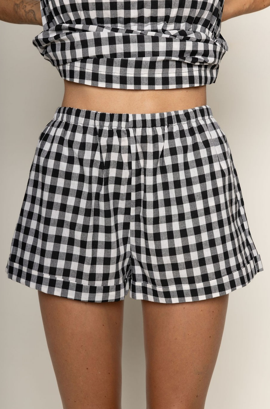 TOP:
Gingham printed flowy tank top
Ruched side ties
Back button closure
Unlined
Length: 21"
Cotton

BOTTOM:
Gingham printed shorts
Elastic waistband
Unlined
Length: 11.5"
Cotton

black and white gingham printed short set
summer set