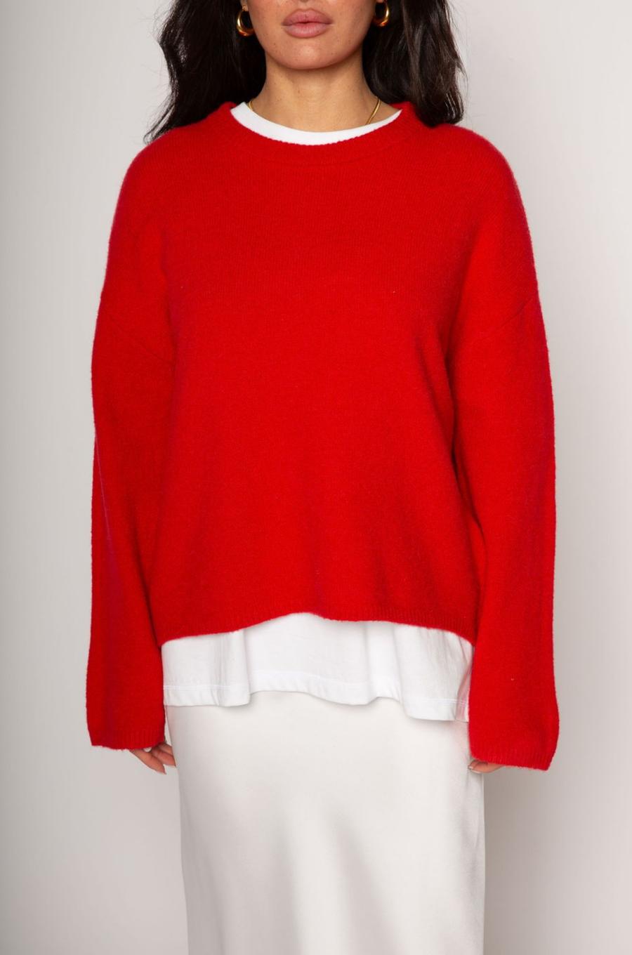 Medium weight knit sweater. Crewneck. Long sleeves. Thin ribbed trim detail at collar, sleeve cuffs, and hemline. Unlined. Pullover style. red pullover sweater. valentines day outfit