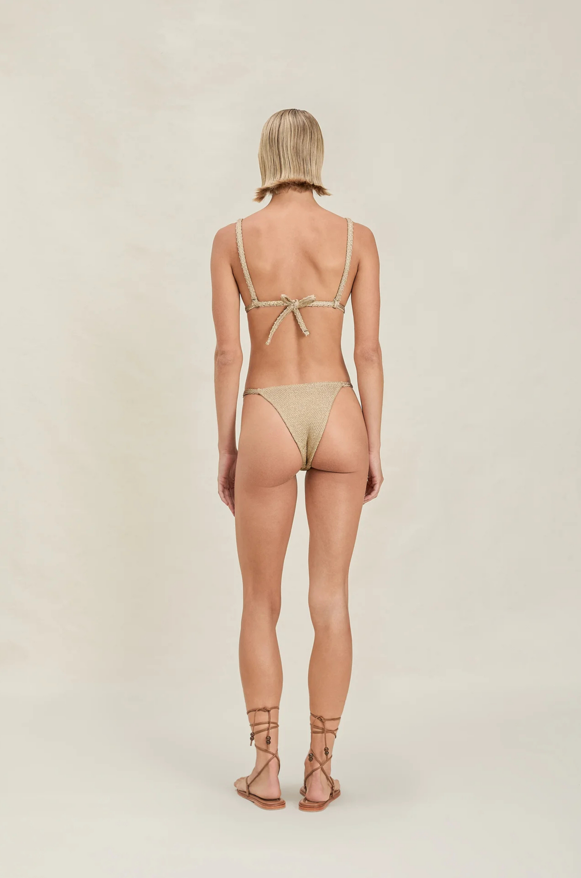 Triangle metallic bikini top
Adjustable straps
Shimmer detailing
gold bikini top