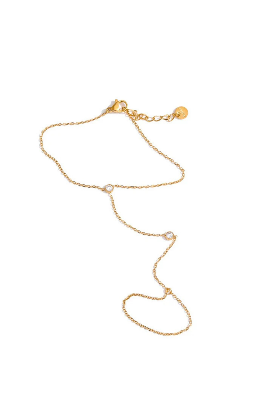 Two bezel-set cubic zirconia stones hand chain
This ultra-sleek, tarnish-free hand chain is crafted from premium stainless steel and designed to keep its shine through every hand wash and pump of sanitizer.
Just the right amount of sparkle, catching the light with your every move.
Lightweight yet bold, it layers effortlessly or stuns solo with a clean, minimalist edge.
Wear it. Wash your hands. Repeat. This is your new everyday flex.
Gold hand chain