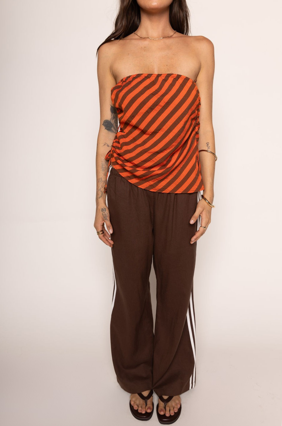 orange and brown Striped knit tube top
Asymmetrical hem
Elastic bust hem
Side cut outs
Side tie closure
Lined
going out tube top