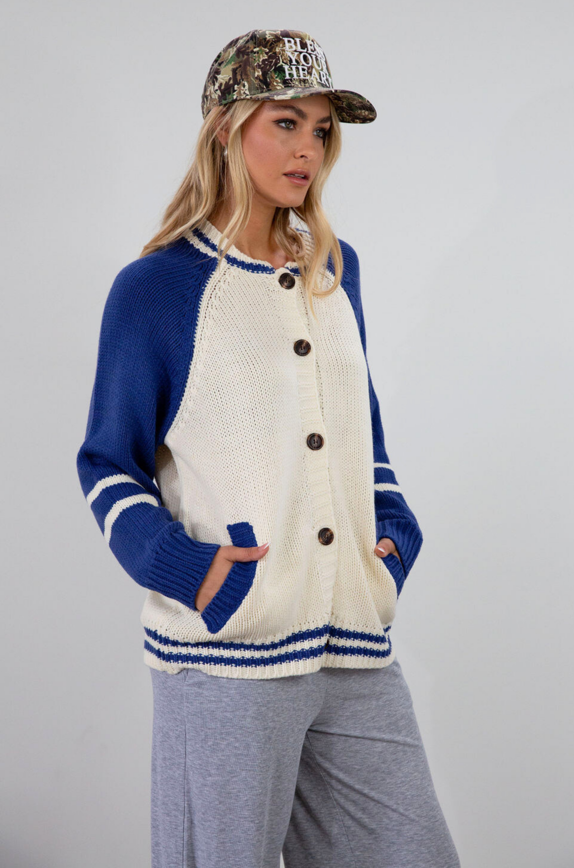 Colorblocked crochet knit cardigan. Crewneck. Long sleeves. Front button down closures. Front pockets. Unlined. ivory and blue sweater cardigan. fall top. fall sweater. oversized sweater