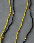 Two separate elastic multicolor beaded belly chains. yellow and black belly chain