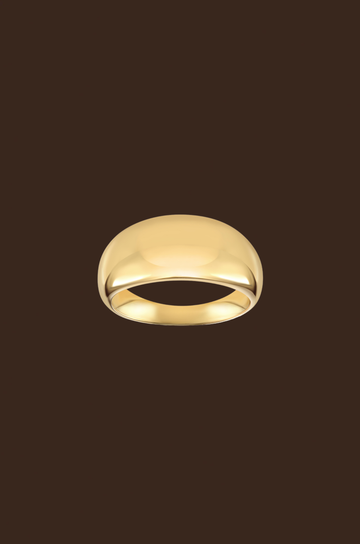 Gold ring on a dark brown background