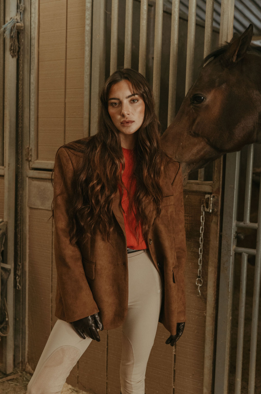 Faux suede single breasted blazer. Collar neckline. Front button closures. Front pockets. Long sleeves with faux button closures. Back slit. Fully lined. brown suede blazer. 