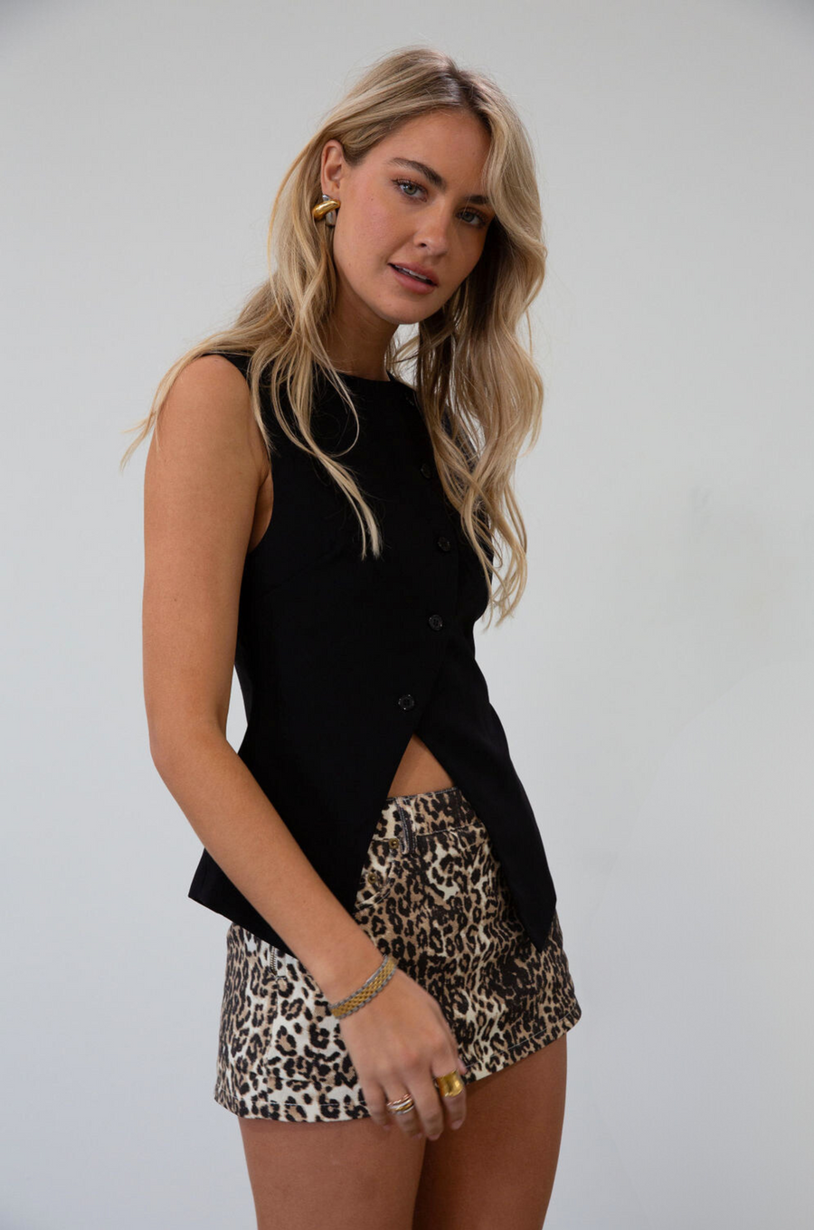Woven sleeveless top. Asymmetric front button down closures. Back slit. Fully lined. black vest top. going out top. fall outfit. fall top