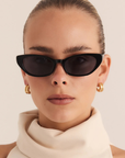 black Slimline cateye sunglasses
Soft, subtle lift through the frame
Acetate frame
Gold metal tip detailing
Polarised, scratch-resistant Category 3 lenses
100% UV protection
Width: 14.5cm / Lens Height: 3.85cm / Arm Length: 14.5cm / Nose Bridge: 2cm