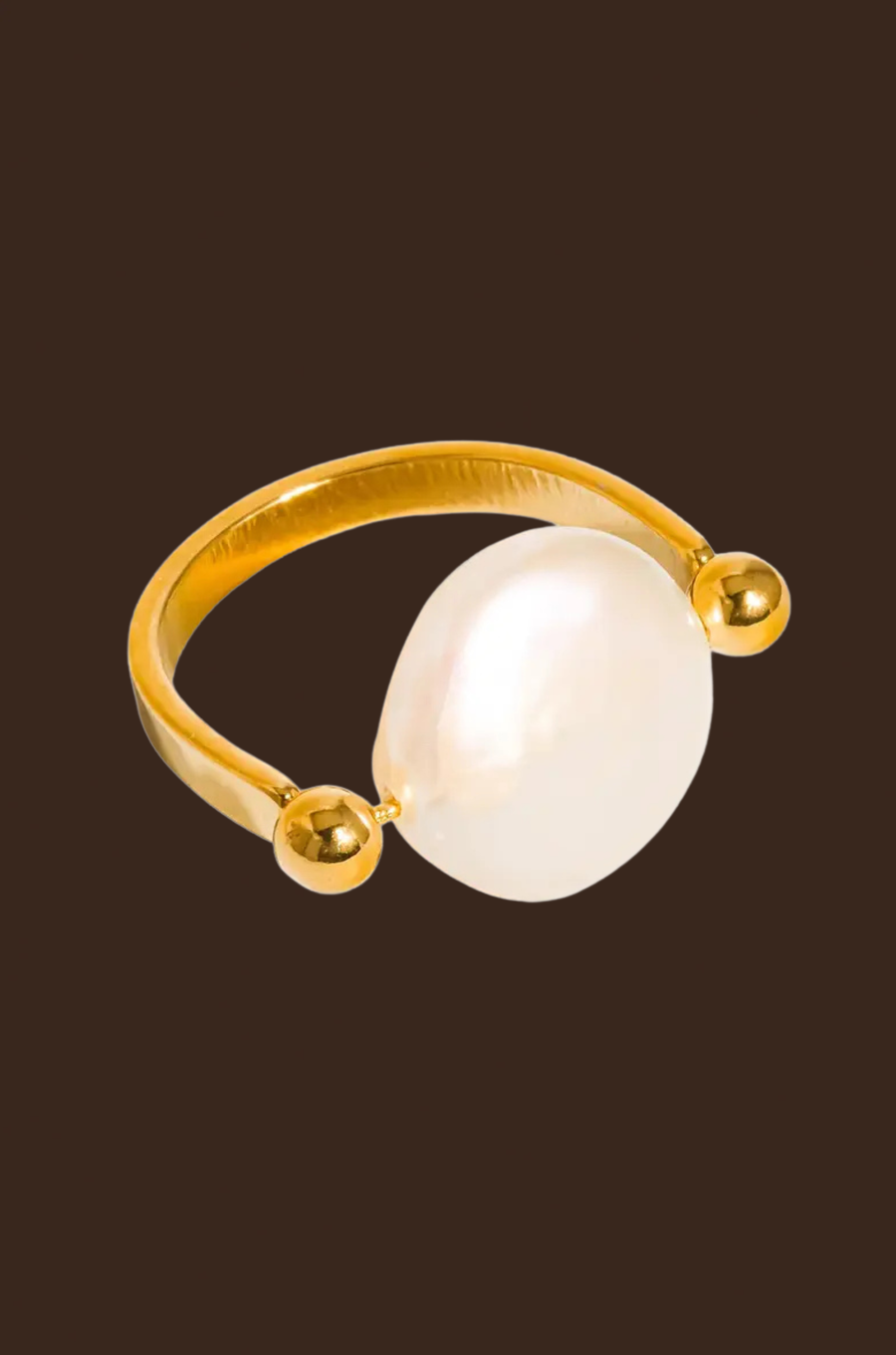Gold ring with a large pearl
18K Gold Non-Tarnish Baroque Pearl Ring
18K Gold Plating
Stainless Steel
Faux Pearl
Size 7 Measurement: 0.682 Diameter/2.14 Circumference
Lead-free
Nickel-safe
Hypoallergenic
Water Resistant
